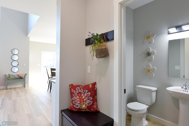 bathroom featuring wood-type flooring, sink, and toilet