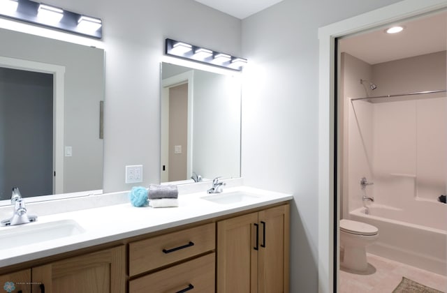 full bathroom featuring tile patterned flooring, bathing tub / shower combination, vanity, and toilet