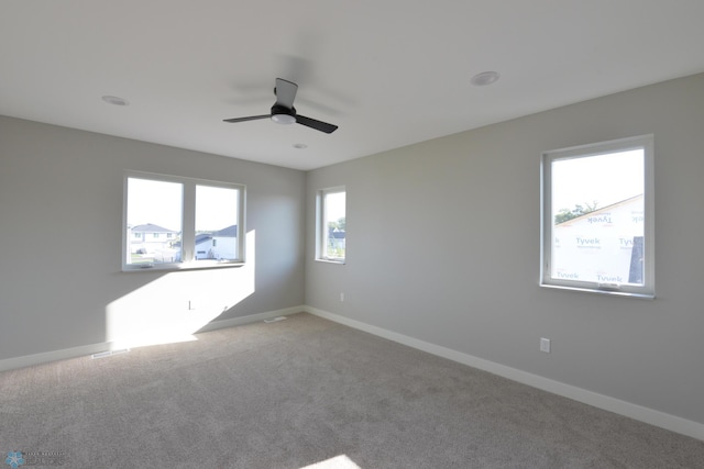 empty room featuring ceiling fan and carpet flooring