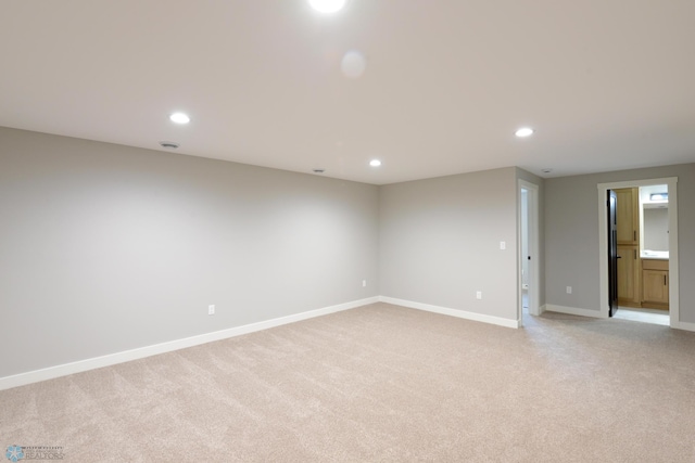 unfurnished room with light carpet