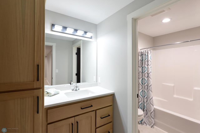 full bathroom with vanity, shower / tub combo, and toilet