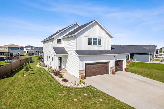 view of front of home featuring a garage, cooling unit, and a front lawn