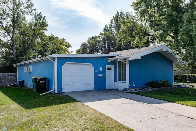 ranch-style home featuring a garage and a front lawn