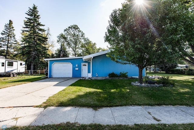 single story home with a front yard and a garage