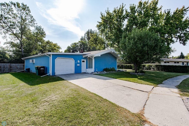 single story home with a garage and a front lawn