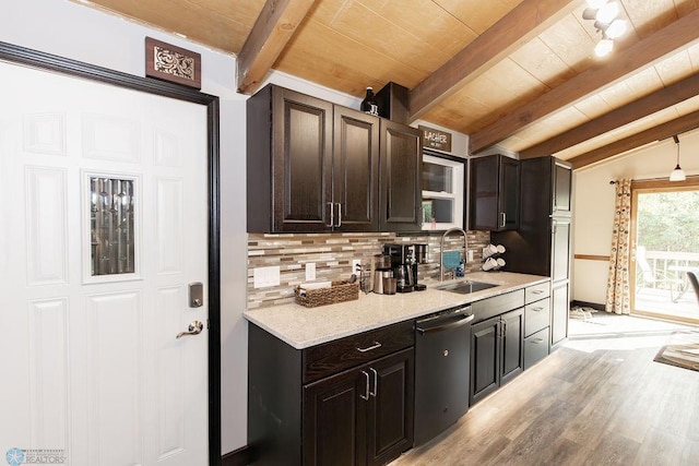 kitchen featuring lofted ceiling with beams, light wood-type flooring, tasteful backsplash, sink, and stainless steel dishwasher