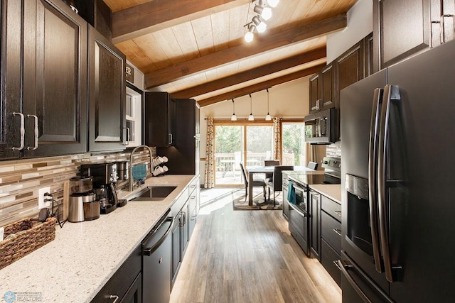 kitchen featuring vaulted ceiling with beams, sink, decorative light fixtures, light hardwood / wood-style flooring, and stainless steel appliances