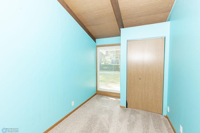 unfurnished bedroom featuring light carpet, wood ceiling, and a closet