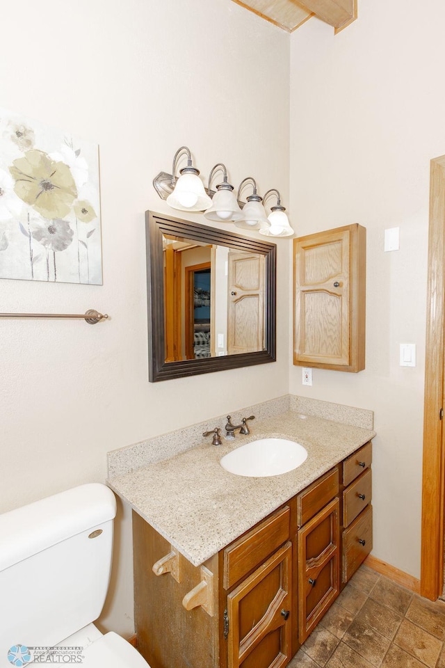 bathroom featuring vanity and toilet