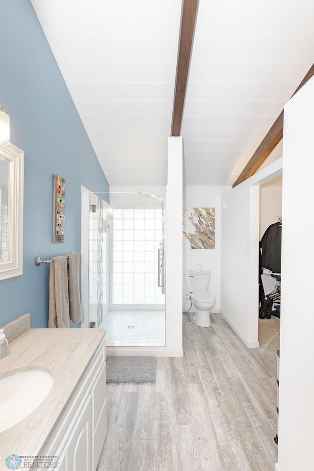 bathroom with vaulted ceiling with beams, vanity, an enclosed shower, hardwood / wood-style flooring, and toilet