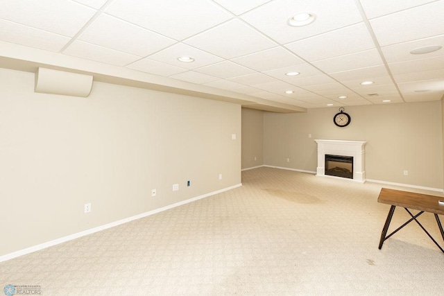 interior space with a drop ceiling and carpet floors