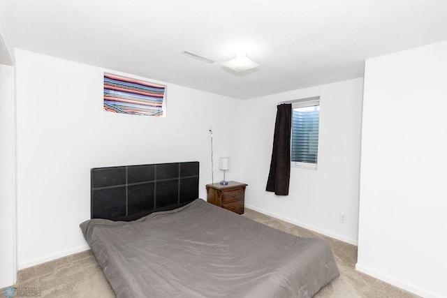 bedroom featuring light carpet