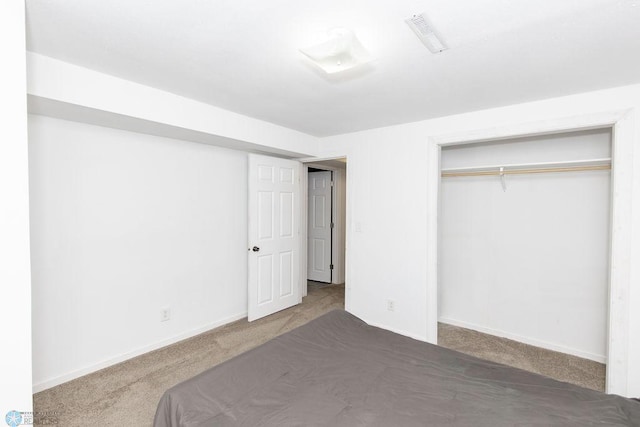 unfurnished bedroom featuring carpet floors and a closet