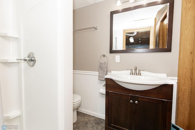 bathroom featuring vanity and toilet