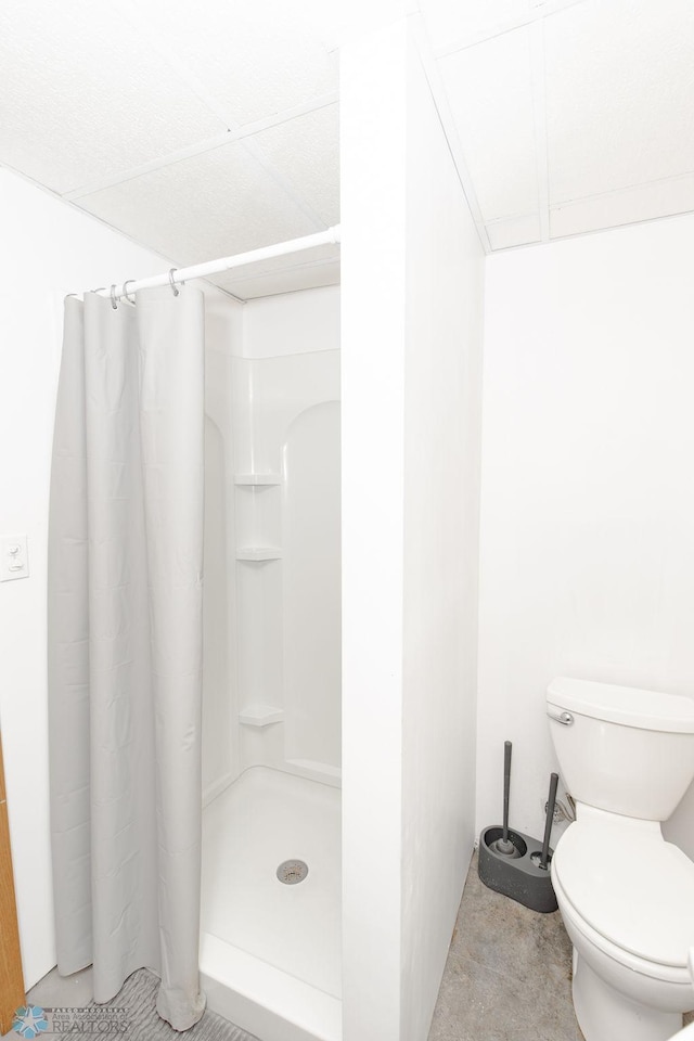 bathroom with walk in shower and toilet