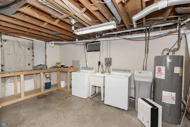 basement featuring electric water heater and washer and clothes dryer