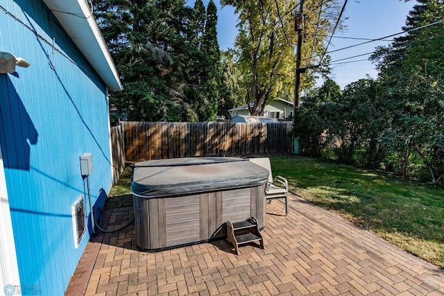 view of patio / terrace with a hot tub