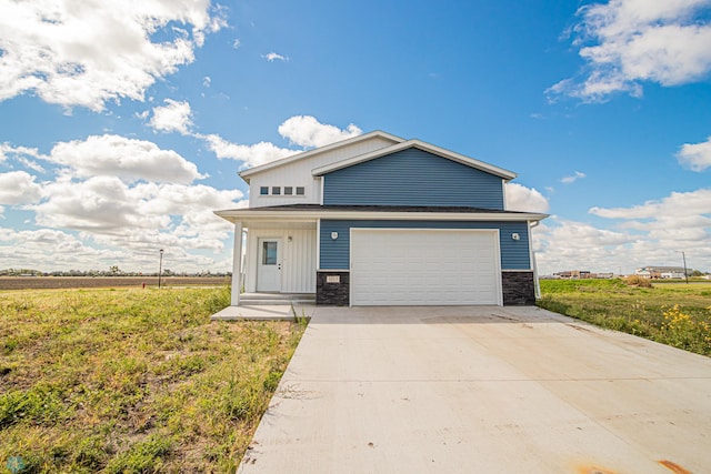 view of front of property with a front yard and a garage