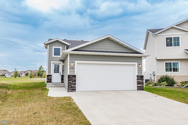 view of front of property featuring a garage and a front lawn