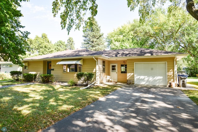 ranch-style house with a front yard and a garage