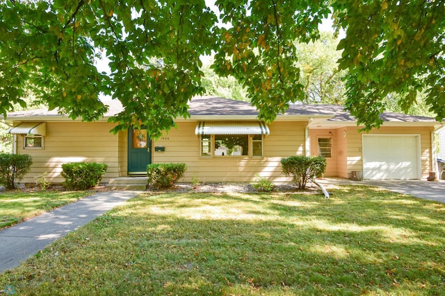 ranch-style house with a front yard and a garage