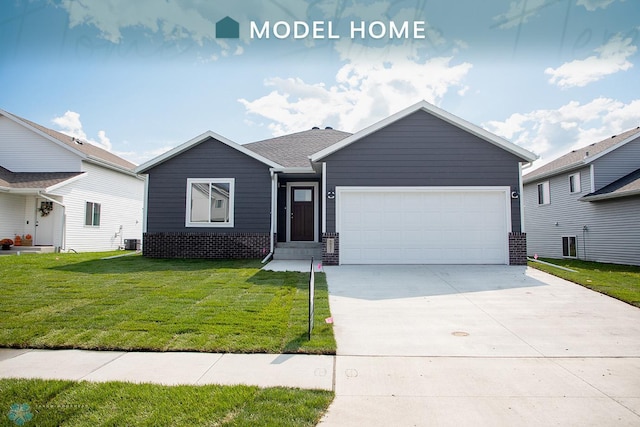 view of front of home with a garage, central AC unit, and a front yard