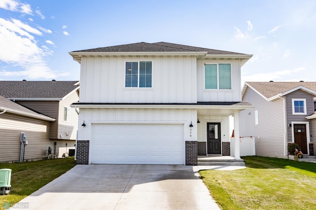 view of front of home featuring a garage and a front lawn