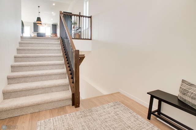 staircase with hardwood / wood-style flooring