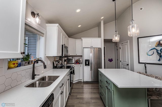 kitchen with dark wood-type flooring, tasteful backsplash, white cabinets, a kitchen island, and stainless steel appliances