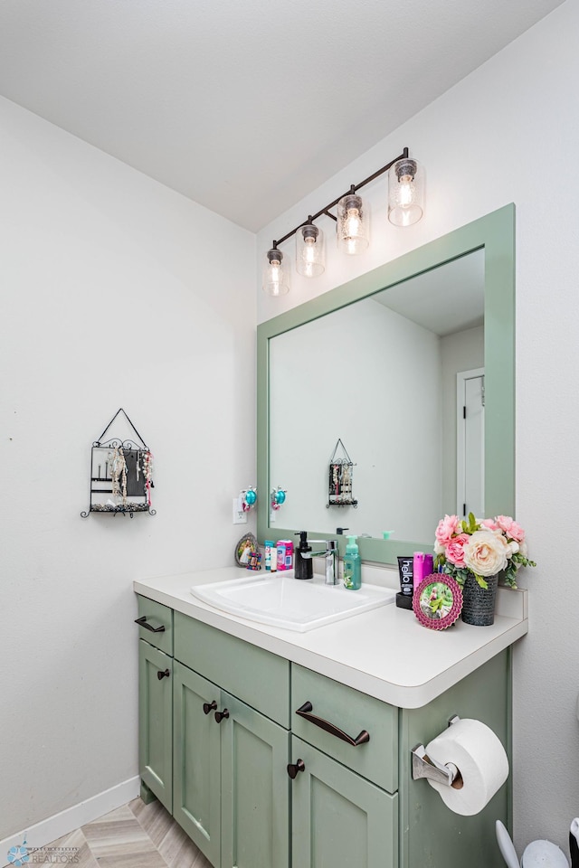 bathroom featuring parquet floors and vanity