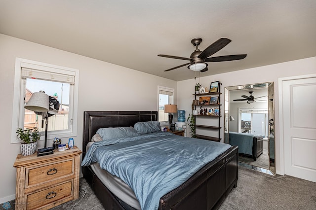 carpeted bedroom featuring ceiling fan and multiple windows