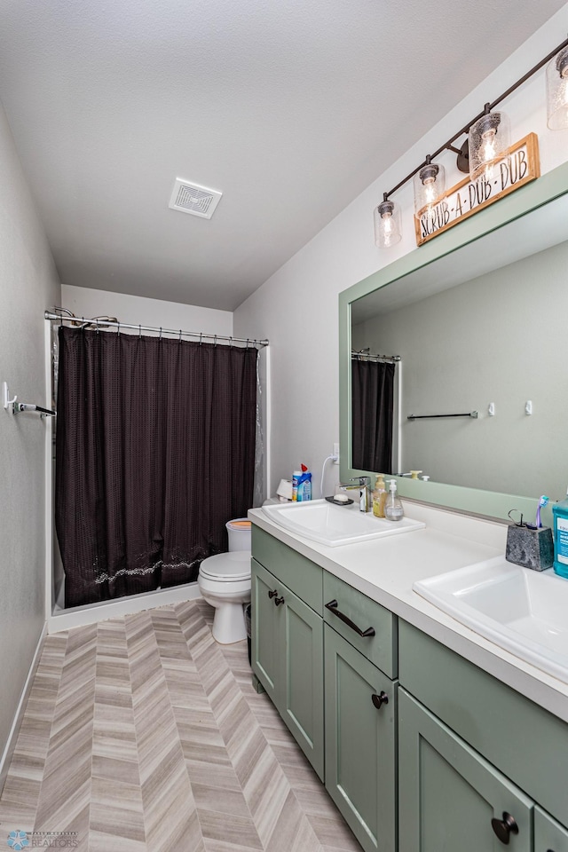 bathroom featuring a shower with curtain, vanity, and toilet