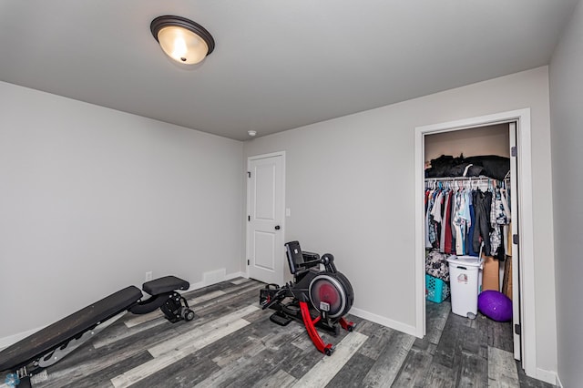 workout area featuring dark hardwood / wood-style floors