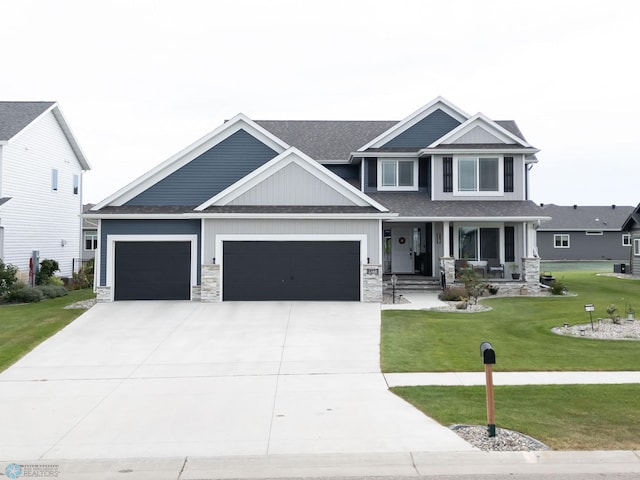 craftsman inspired home featuring a front yard, a porch, and a garage