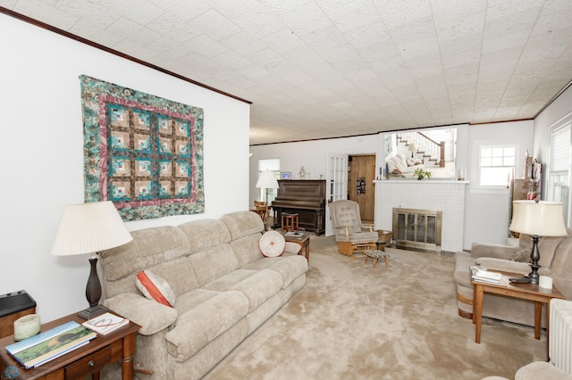 carpeted living room featuring crown molding and a fireplace