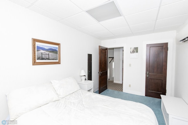 bedroom featuring a drop ceiling and carpet flooring