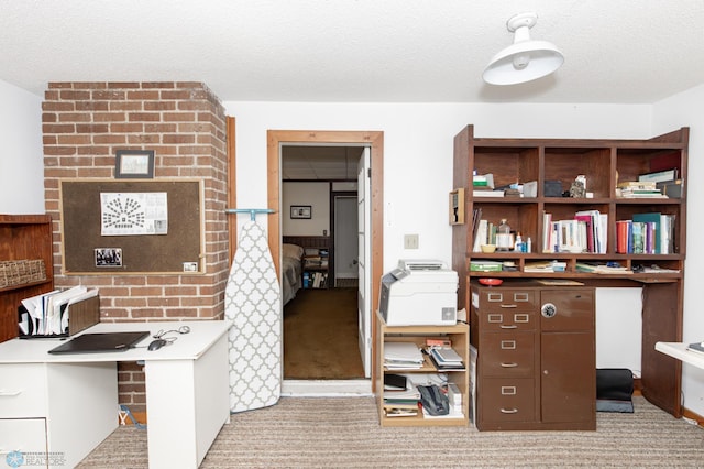 carpeted office featuring a textured ceiling