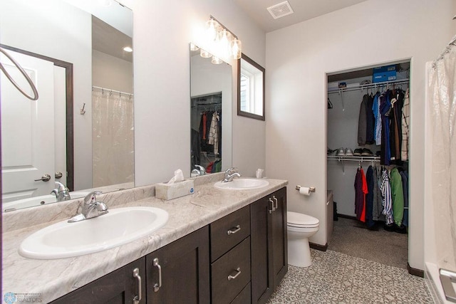 bathroom featuring vanity, toilet, and curtained shower