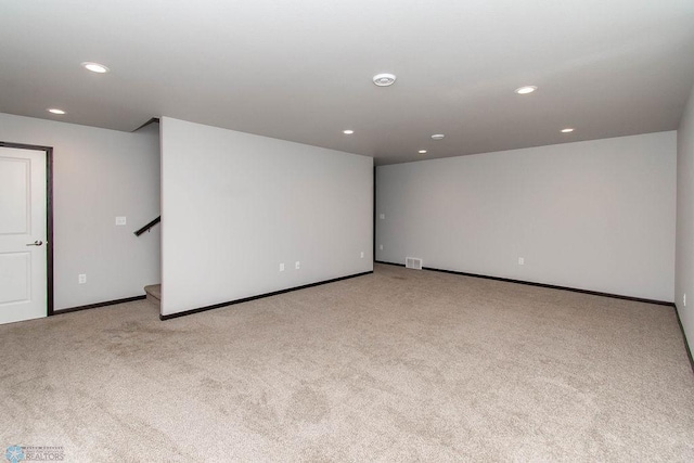 unfurnished room featuring light carpet