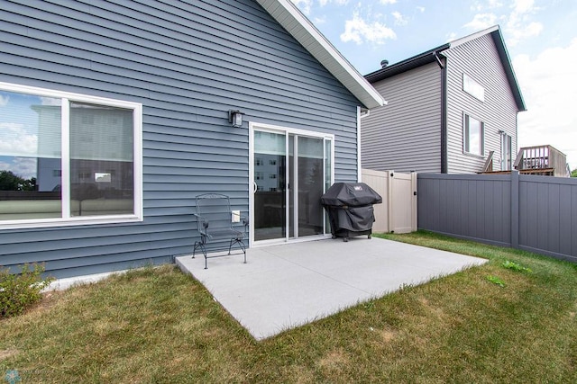 rear view of house featuring a yard and a patio