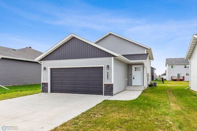 view of front of house with central AC unit, a garage, and a front lawn