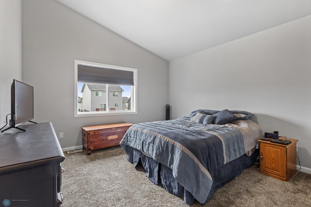 bedroom featuring vaulted ceiling and carpet flooring