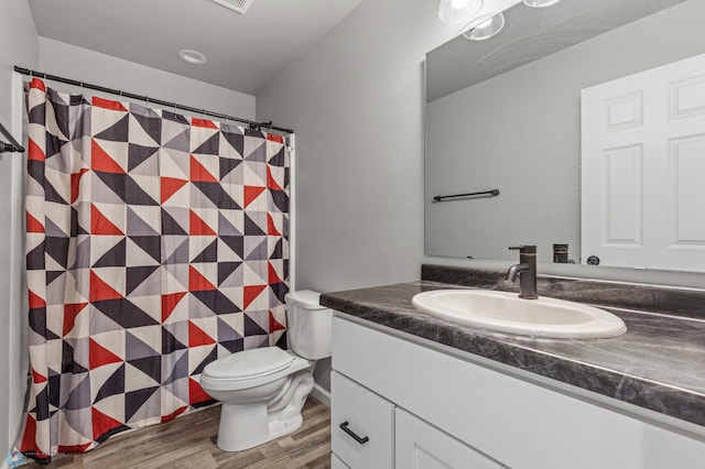 bathroom featuring a shower with shower curtain, vanity, toilet, and hardwood / wood-style flooring