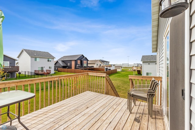 wooden deck featuring a yard