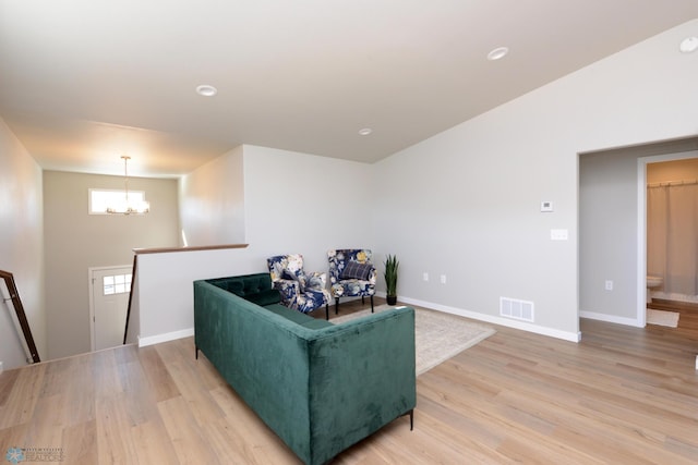 living room with an inviting chandelier and wood-type flooring