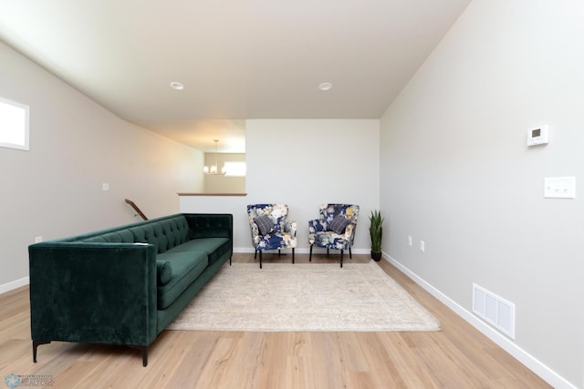 interior space with hardwood / wood-style flooring and a chandelier