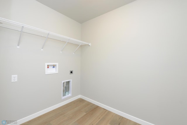 laundry area featuring hookup for a washing machine, hardwood / wood-style floors, and electric dryer hookup