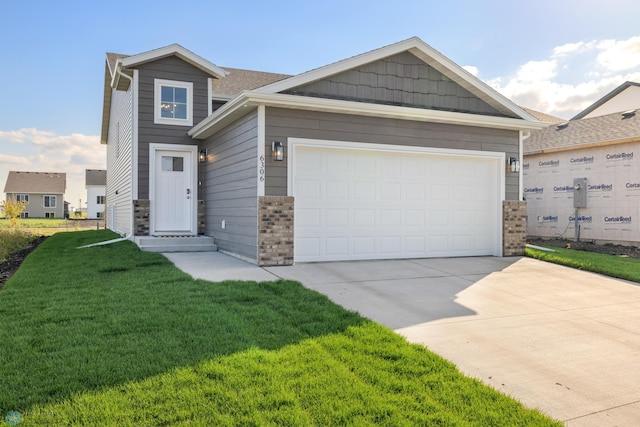 craftsman-style home featuring a front yard and a garage