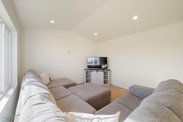 living room featuring light hardwood / wood-style flooring and lofted ceiling