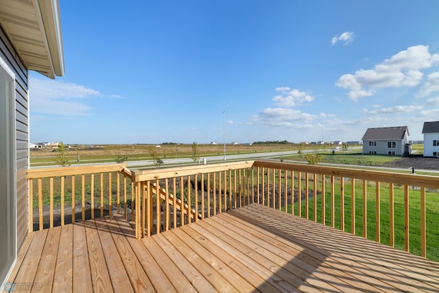 wooden terrace featuring a lawn